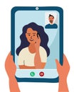 Caucasian woman and man are on the tablet device screen. Hands holding smartphone with video call. girl with dark blue hair.