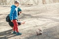 Caucasian woman mother and son taking picture photo of squirrel in park. Mom and boy kid snapping smartphone photos of a wild Royalty Free Stock Photo