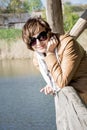 Caucasian woman on a pier at the lake