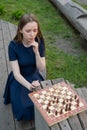Caucasian woman playing chess outdoors. Royalty Free Stock Photo