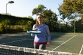 Caucasian woman playing tennis bouncing ball on racket on outdoor tennis court Royalty Free Stock Photo