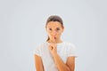 Caucasian woman portrait doing silence gesture with finger. White color. Censorship concept