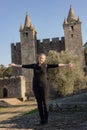 Caucasian woman posing in front of medieval gothic public castle in Portugal