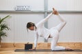 Caucasian woman practicing yoga with a lot of elasticity