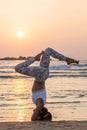 Caucasian woman practicing yoga at seashore of tropic ocean Royalty Free Stock Photo