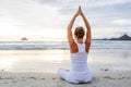 Caucasian woman practicing yoga at seashore of tropic ocean Royalty Free Stock Photo