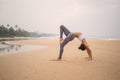 Caucasian woman practicing yoga at seashore of tropic ocean Royalty Free Stock Photo