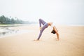 Caucasian woman practicing yoga at seashore of tropic ocean Royalty Free Stock Photo