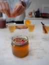 Caucasian woman preparing flutes glasses with fresh and homemade kombucha tea