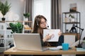 Caucasian woman presenting financial report to colleagues through video call on laptop. Royalty Free Stock Photo