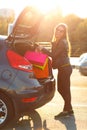 Caucasian woman putting her shopping bags into the car trunk Royalty Free Stock Photo