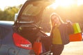 Caucasian woman putting her shopping bags into the car trunk Royalty Free Stock Photo