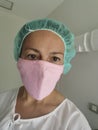 Caucasian woman ready for blepharoplasty or eyelid beauty - Female surgeon or hospital patient with pink mask in a room hospital