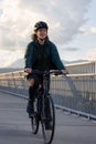 Caucasian Woman riding on a bicycle on a bike lane at Port Mann Bridge Royalty Free Stock Photo