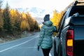 Caucasian woman on road trip enjoying mountain landscape. Royalty Free Stock Photo