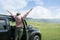 Caucasian woman on road trip enjoying mountain landscape. Royalty Free Stock Photo