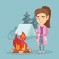 Caucasian woman roasting marshmallow over campfire
