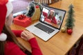 Caucasian woman in santa hat making christmas laptop video call with smiling female friend Royalty Free Stock Photo