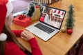 Caucasian woman in santa hat making laptop christmas video call with smiling female friend Royalty Free Stock Photo