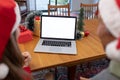 Caucasian woman and senior man having video call on laptop with copy space at christmas time Royalty Free Stock Photo