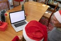 Caucasian woman and senior man having video call on laptop with copy space at christmas time Royalty Free Stock Photo