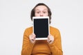 Caucasian woman shows a screen digital tablet. Royalty Free Stock Photo