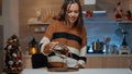 Caucasian woman sitting in christmas decorated kitchen Royalty Free Stock Photo