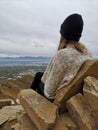 Caucasian woman sitting on a rocky sofa enjoying the view from Living Room Trailhead hike