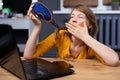 Caucasian woman sleeping in sleep mask sitting at the wooden table, after tired work in front of computer with Royalty Free Stock Photo