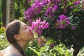 caucasian woman smelling flowers in jungle park Royalty Free Stock Photo