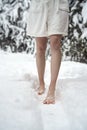 Woman standing barefoot in snow Royalty Free Stock Photo