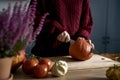 Caucasian woman start cutting pumpkin for soup at the kitchen Royalty Free Stock Photo