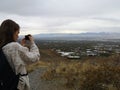 Caucasian woman taking a photo to the view from Living Room Trailhead hike