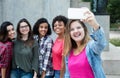 Caucasian woman taking picture of girlfriends with phone Royalty Free Stock Photo