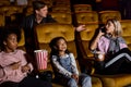 Caucasian woman talking on phone in the cinema Royalty Free Stock Photo