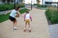 Caucasian woman teaches her daughter to skate on roller skates. Royalty Free Stock Photo