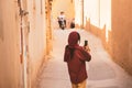 Caucasian woman tourist explore walk through arch corridor in Yazd old town area