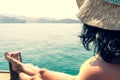 Caucasian woman tourist relax lay on vacation on cruise ship deck enjoy sunny persian gulf panorama with rocky mountains cliffs.