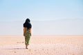 Caucasian woman tourist stand on Maharlu pink salt lake shore. Travel destination Iran in Shiraz