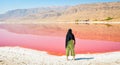 Caucasian woman tourist stand on Maharlu pink salt lake shore. Travel destination Iran in Shiraz