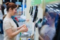 Caucasian woman uses a self-checkout counter. Self-purchase of groceries in the supermarket without a seller Royalty Free Stock Photo