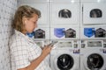 Caucasian woman waiting at the self service laundry Royalty Free Stock Photo