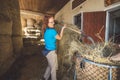 Strong caucasian woman working at the ranch moving hay around for the horses Royalty Free Stock Photo