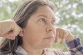 caucasian woman 40-45 years old plugged ears with her fingers, auditory hallucinations, earache, hearing loss, deafness, Acute Royalty Free Stock Photo