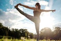 Caucasian woman in yoga standing balance Utthita Hasta Padangusthasana pose. Back view