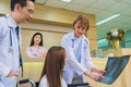 caucasian women doctor explain xray result to patient sit on wheelchair