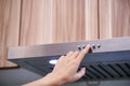 Caucasian women hand using the range hood in modern kitchen Royalty Free Stock Photo