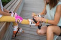 Caucasian woman helping her daughter put on roller skates. Royalty Free Stock Photo