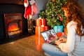 Caucasian woman making laptop christmas video call with smiling female friend Royalty Free Stock Photo