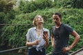 Caucasian woman and man having a bad cellular signal in the nature travel problem concept